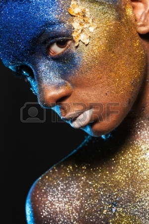 23701123-portrait-of-a-woman-who-is-posing-covered-with-blue-and-gold-paint